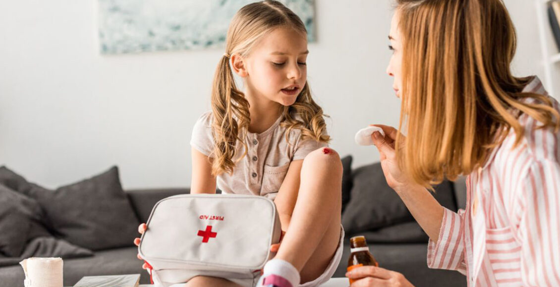 mother treating injured daughter with an Airbnb first aid equipment