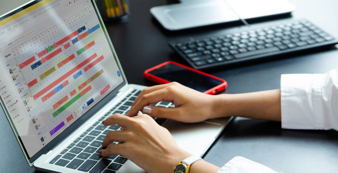 woman working with Airbnb management software on laptop