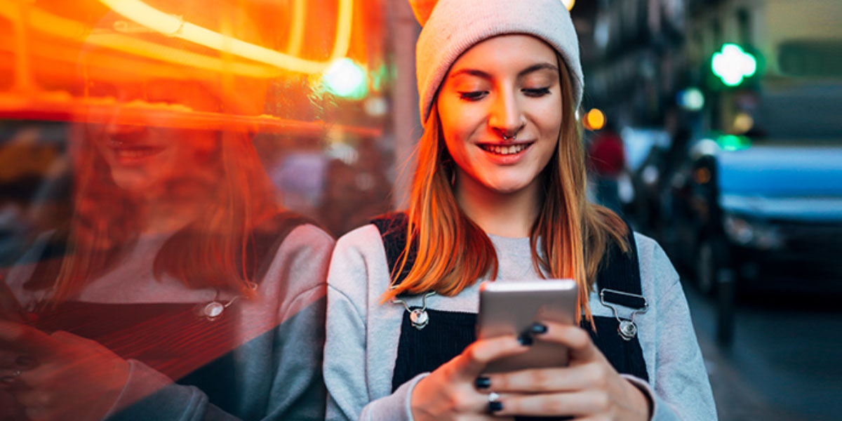 a girl smiling while texting